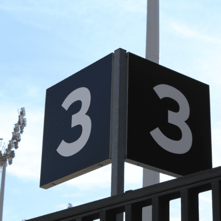 Image of a corner sign with two visible sides, both displaying the number 3